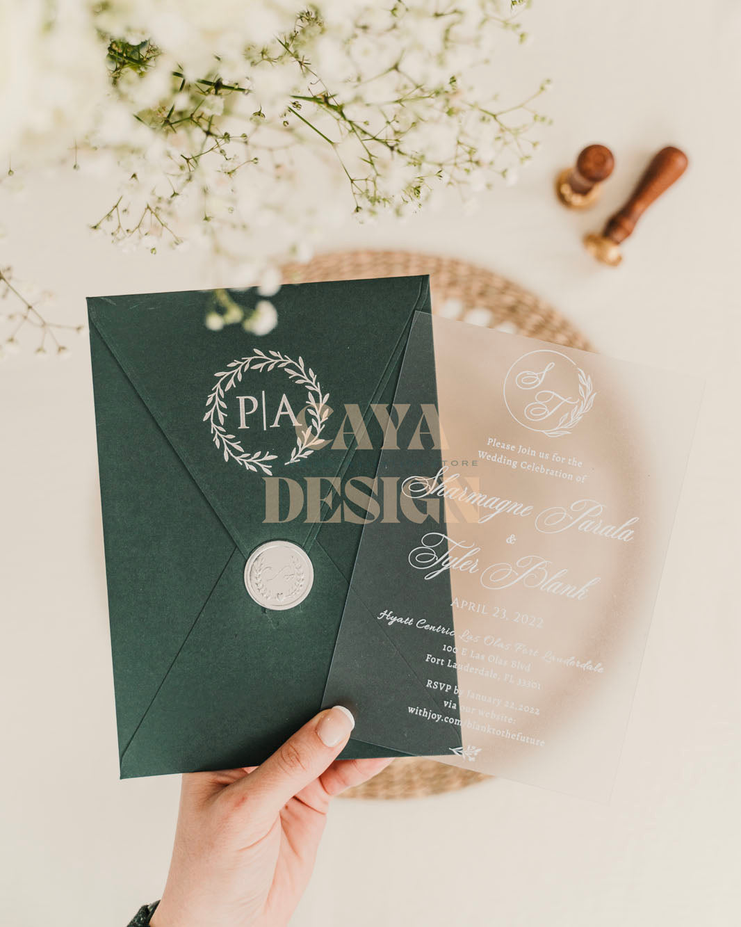 Emerald Green Paper Vertical Wedding Invitation with Acrylic Insert Card and Silver Foil details in hands close up