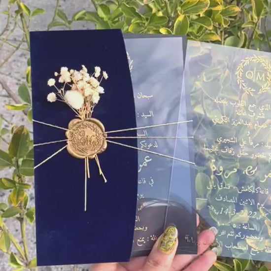 Video of a Navy Blue Velvet Half Fold Wedding Invitation with Acrylic Insert Card, Gold Foil details, wax seal and flowers