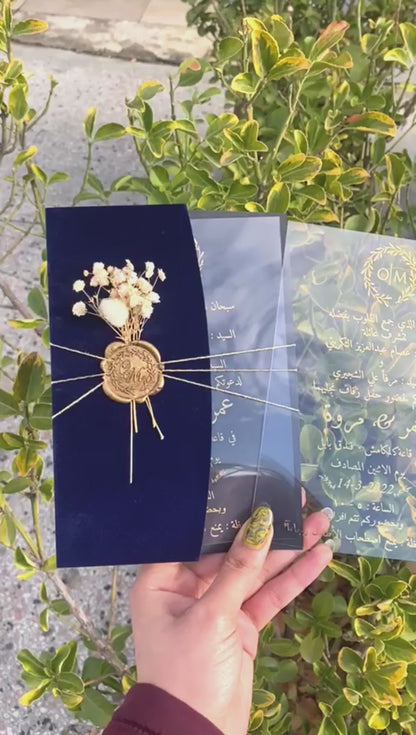 Video of a Navy Blue Velvet Half Fold Wedding Invitation with Acrylic Insert Card, Gold Foil details, wax seal and flowers