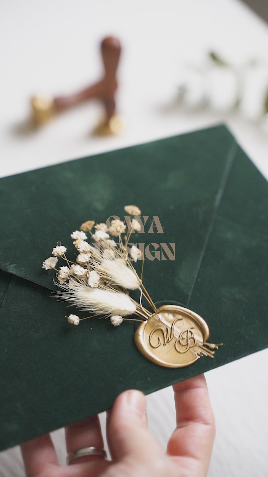 Video of a Emerald Green Velvet Horizontal  Wedding Invitation with Acrylic Insert Card, Gold Foil details, wax seal and flowers