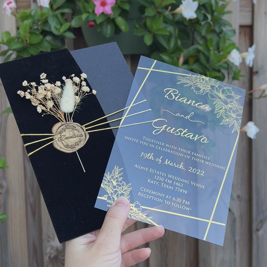 Video of a Black Velvet Half Fold Wedding Invitation with Acrylic Insert Card, Gold Foil details, wax seal and flowers